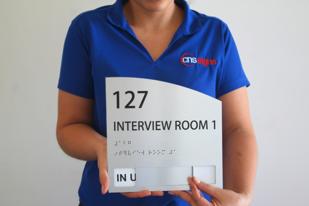 Brushed aluminum ADA braille sign, interview room 127 (unit 2)