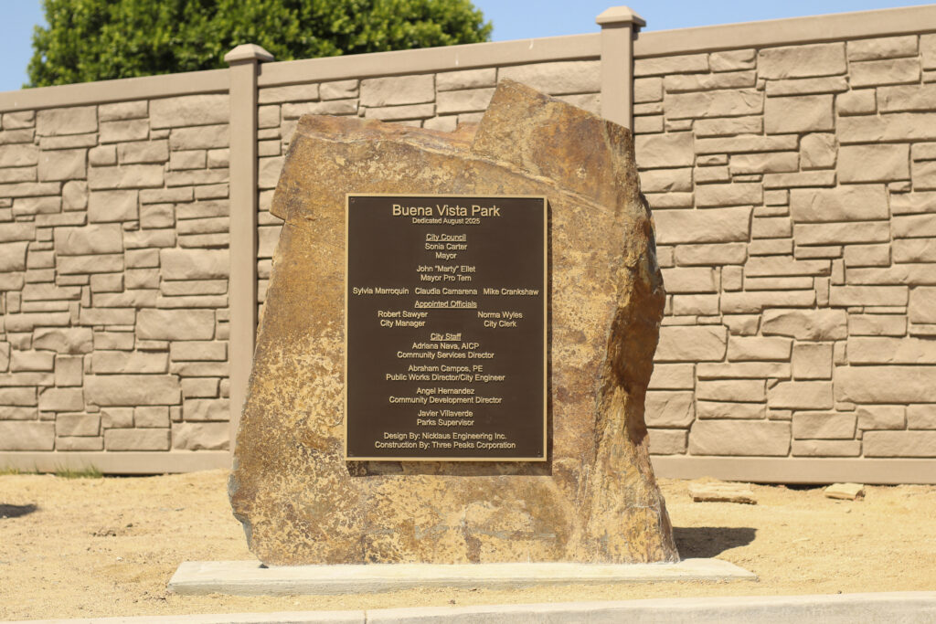 Commemorative monument sign for Buena Vista Park in El Centro, CA, featuring a bronze plaque mounted on a natural stone.